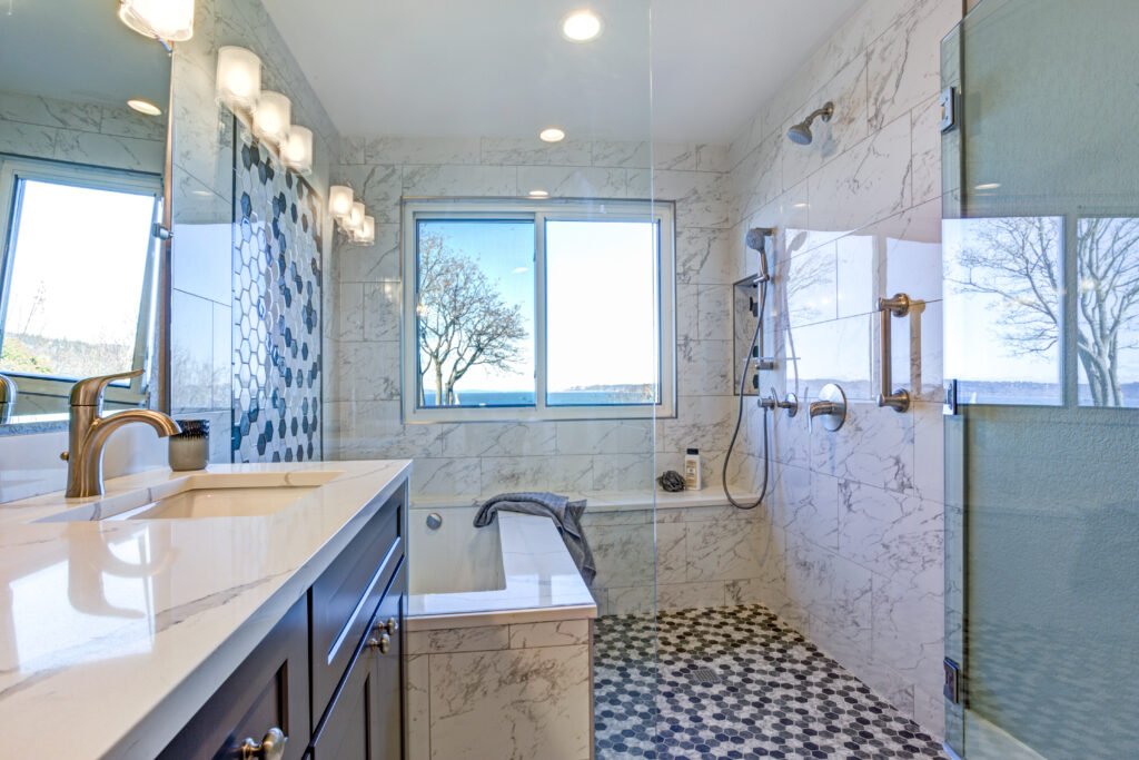 Bathroom design with marble shower surround and mosaic accent tiles
