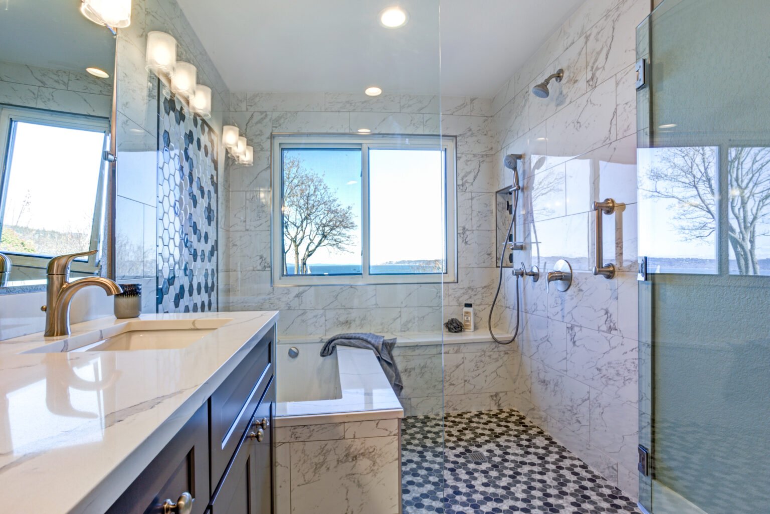 Bathroom design with marble shower surround and mosaic accent tiles