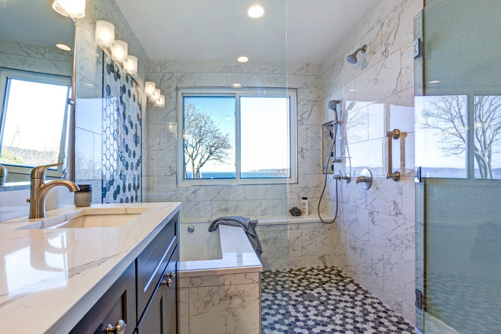 Bathroom design with marble shower surround and mosaic accent tiles